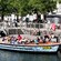 Passengers aboard a tour boat docked alongside the canal